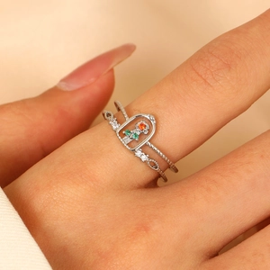 Macro detail of silver layered ring with colorful zircon rose and beaded texture