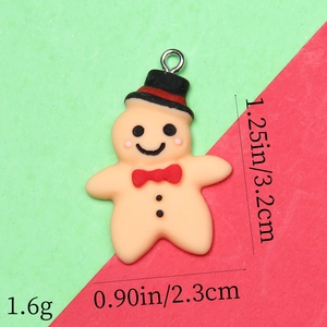 Detailed view of gingerbread man resin pendant with 3.2cm height and 2.3cm width dimensions