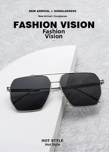 Detail of silver double bridge sunglasses with dark lenses on a white display stand