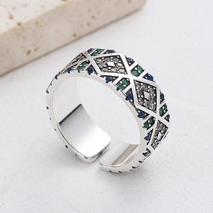 Macro shot of 925 silver ring with colorful zircons and retro geometric textures