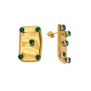 Macro view of gold plated rectangular earrings with five green faceted gemstones