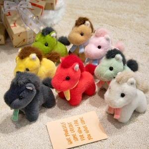 Colorful plush horse dolls with scarves for kids and gift boxes on white carpet