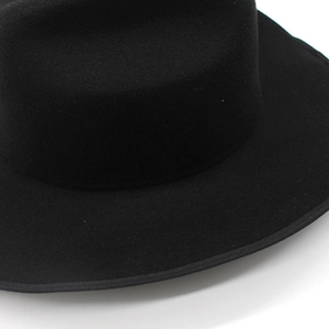 Detailed macro view of black wool felt fedora showing high-quality texture and stitching