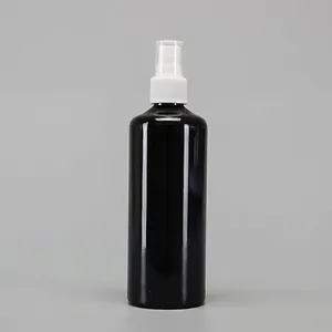 Detail view of a black glossy plastic spray bottle with white pump and clear safety cap