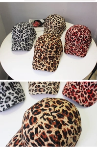 Detailed close-up of leopard print baseball caps showing twill fabric texture in three colors