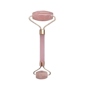 Pink quartz face roller with gold-plated metal frame for facial massage on white background