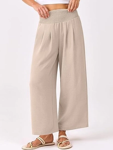 Détail de la taille haute élastique et du tissu beige texturé sur le pantalon large
