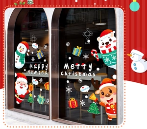 Detail of Christmas window decals with Santa and reindeer on a coffee shop glass pane