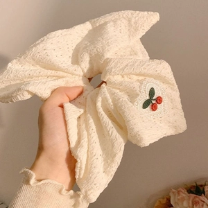 White lace scrunchie featuring cherry embroidery and delicate openwork floral details