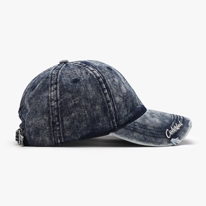 Acid wash denim baseball cap in navy blue with colorful embroidery and distressed brim