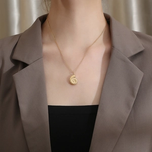 Detailed close-up of a 18K gold minimalist conch shell pendant on a dainty chain