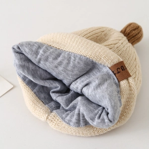 Bonnet d'hiver en tricot pour bébé avec doublure chaude et pompon de couleur beige doux