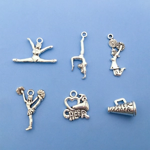 Detail view of silver cheerleader charms with Cheer Leader text on blue background