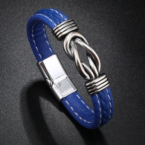 Detail view of blue braided leather bracelet with silver metal knot and magnetic clasp
