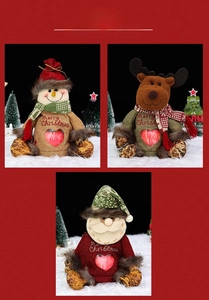 Detailed view of Christmas burlap gift bags with plush Santa, Snowman and Reindeer dolls