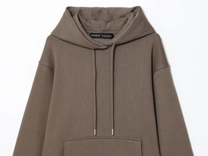 Detail of dark brown knit hoodie featuring a drawstring hood and classic kangaroo pocket
