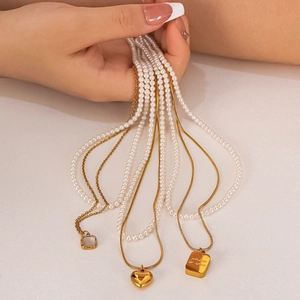 Multi-layer 18K gold plated necklace with white shell heart and pearl chain detail