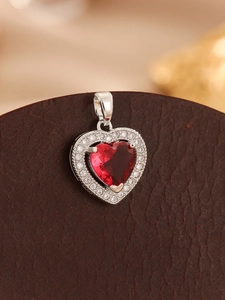 Macro detail of sparkling red heart gemstone pendant with micro-paved cubic zirconia