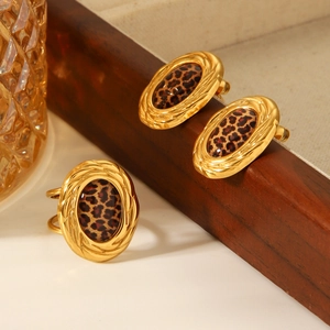Elegant 18k gold plated leopard print earring and ring set on minimalist wooden tray