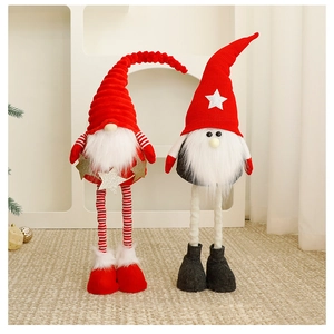Detail of red and grey knitted Christmas gnomes with long legs and plush fur texture