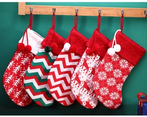 Close-up of five knitted Christmas stockings with reindeer and snowflake patterns