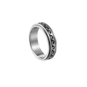 Detail of rotating stainless steel spinner ring featuring black wave pattern on silver band