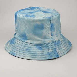 Detailed view of blue and white tie-dye cotton twill texture on a reversible bucket hat