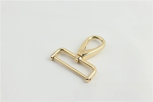 Close-up of polished light gold swivel lobster clasp with screw rod for bag straps