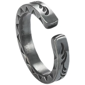 Detail of vintage silver spearhead ring with intricate engraved tribal patterns