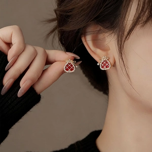 Elegant gold-plated lucky bag stud earrings with red enamel and sparkling zircon accents
