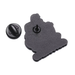 Close-up of black metal badge back with durable rubber clasp on white background