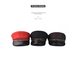 Detail showing red black and coffee military caps with star rivets and gold chains