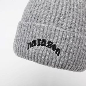Gray chunky knit beanie with black paragon embroidery on folded cuff for winter warmth