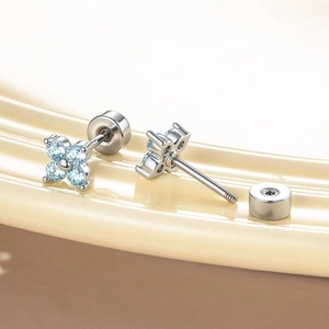 Exquisite clover stud earrings with light blue zircon and threaded screw backs in a tray