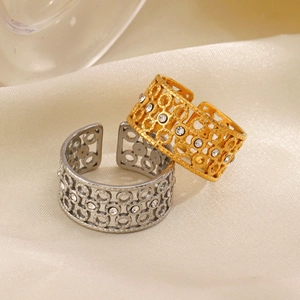 18K gold plated hollow geometric rings set with zircon on beige satin background