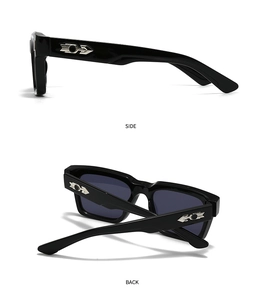 Detail view of square black sunglasses with silver arrow metal décor on the side and back