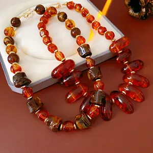 Bohemian irregular amber bead necklace with gold spacers and vintage resin charms