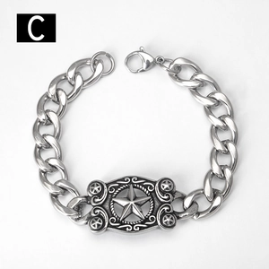 Detail view of silver Cuban chain bracelet featuring a retro star engraved metal plate