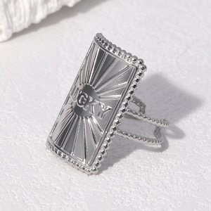 Adjustable stainless steel ring with LUCKY engraving and radial sunburst pattern