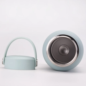 Detail view of the stainless steel interior and matte lid of this light blue sports bottle