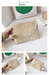 Detail of cream white straw envelope bag with pom-pom charms and leather wrist strap
