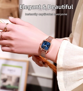 Close-up of elegant rose gold square watch with a deep blue dial on model's wrist