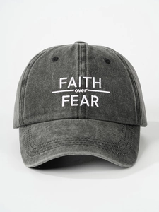 Macro view of white FAITH over FEAR 3D embroidery on washed grey cotton baseball cap