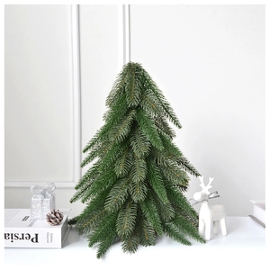 Close-up of artificial green Christmas tree with pine cones and reindeer decor