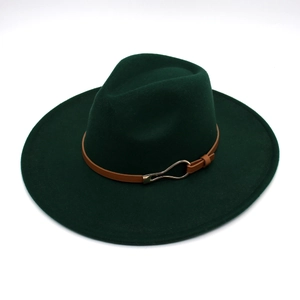 Detail of dark green wide brim fedora hat with brown leather band and gold buckle