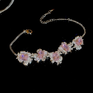 Detailed view of pink zircon flower bracelet with sparkling rhinestones and silver chain