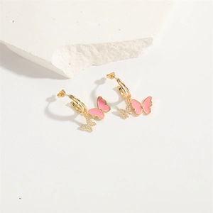 Fashionable gold bow drop earrings with pink glaze and sparkling zircons on stone
