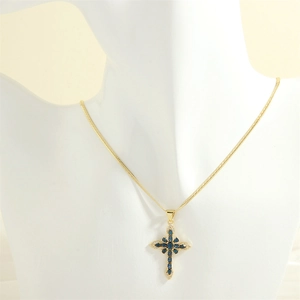 Detail of cross pendant necklace with blue stones on a mannequin display