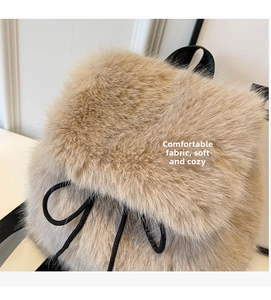 Detail view of the beige faux fox fur texture and soft material of the plush backpack