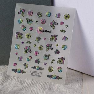 Detailed macro of 5D embossed nail stickers featuring colorful floral and heart designs